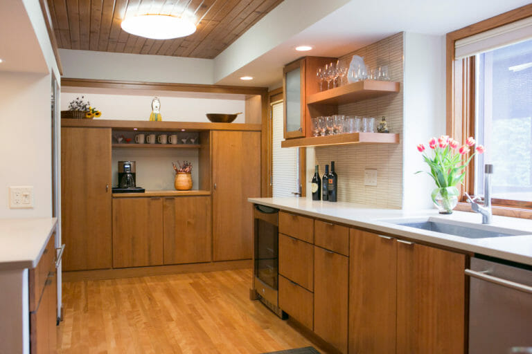 Mid-century designed kitchen with hardwood floors and wood detailed cabinets, designed by Silver Leaf Interiors in Madison, WI.