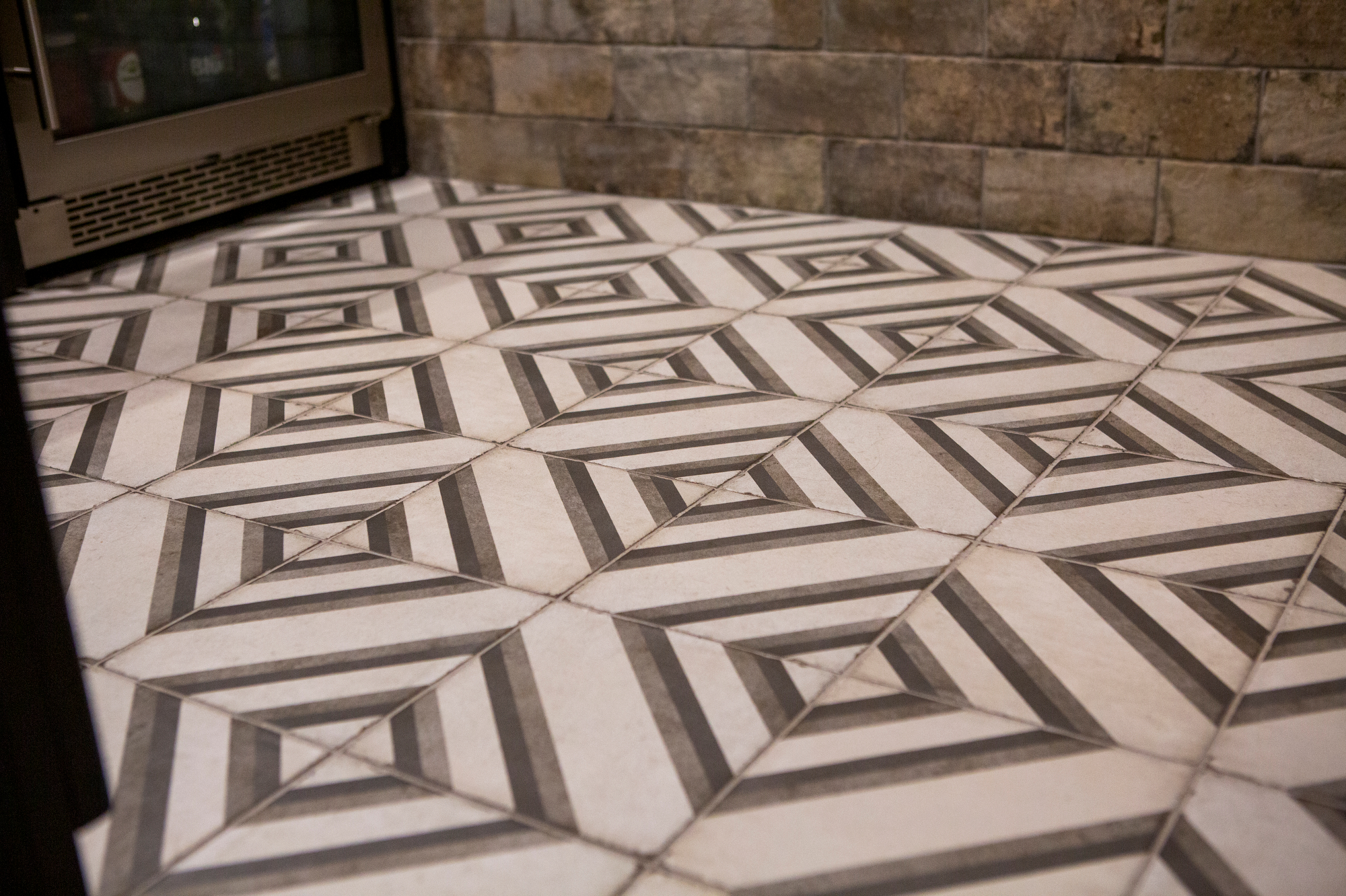 Geometric floor tiles with a 3D optical illusion pattern.